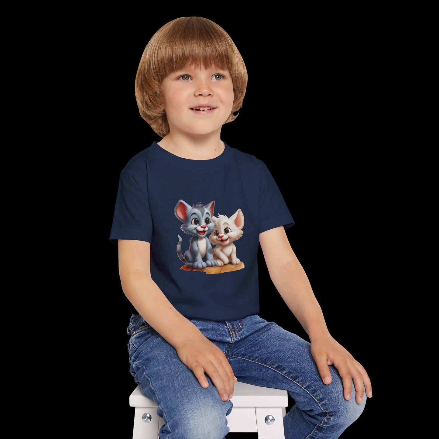 Child wearing a navy blue t-shirt with cartoon cats on a blue background